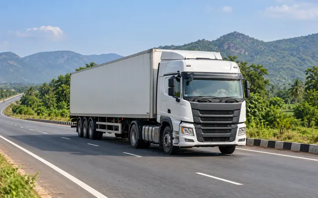 Freight truck travelling along an inland highway for cross-border road transport